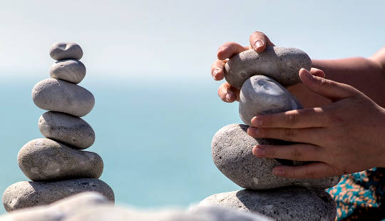 Accepting and Integrating All of Who and What We Are meditation stone towers in the process of being created