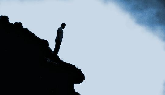 Miracle on the Mountain: The Call to Service man standing alone on the edge of a cliff