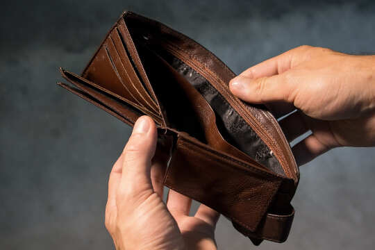 Fears of Managing Money: Dealing with Family and Societal Programming image of hands holding an open wallet... an empty wallet