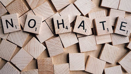Vaccination or No Vaccination? That Is Not the Question Here... Scrabble letters that spell out: NO HATE