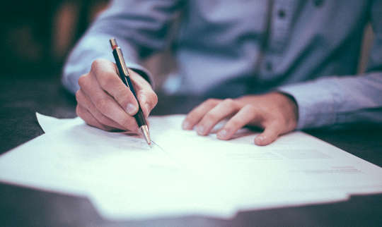 Channeling As A Healing Tool and Its Impact On Grief picture of a man writing on sheets of paper