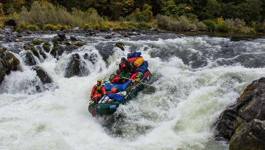 The Power of Powerlessness: Riding the Rapids of Life group of people riding the rapids in a raft