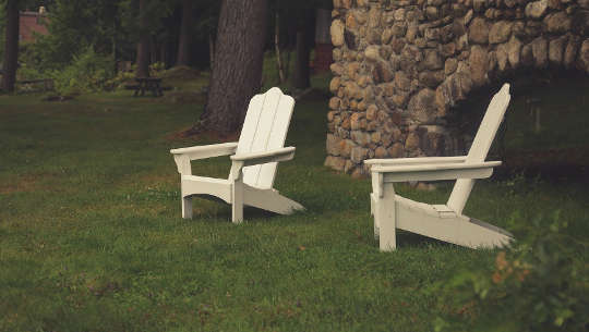 Turning From Doing To Being two empty lawn chairs in from of a rock wall