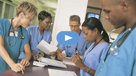 Why Quality Healthcare May Not Be As Difficult As It Seems group of healthcare professionals standing around a desk or table