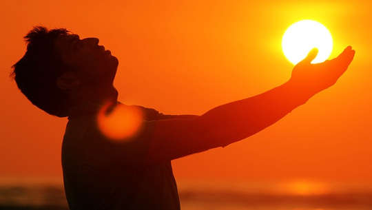 What Is SAD and How You Can Lessen The Symptoms man outside with hands outstretched to the sun