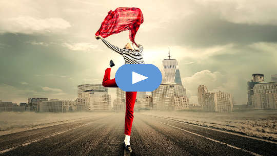 Having the Courage to Be True to Ourselves woman dancing in the middle of an empty highway with a city skyline in the background