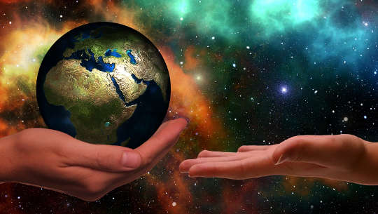 When The Call Comes: Listen and Take Action one hand holding the planet, the other open ready to receive it