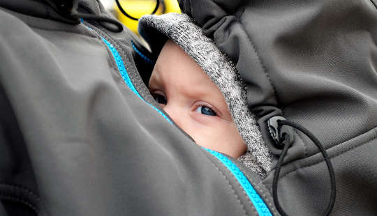 What If Your Life Purpose Is Simply Love and Joy? a baby sheltered inside his mother's jacket on her breast