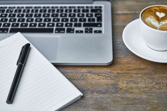 Today's Inspiration computer keyboard, notebook and pen, and cup of coffee