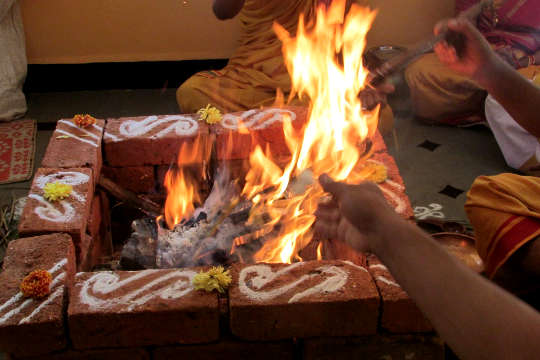 Clearing Your Energy Field: The Path of the Modern Mystic a picture of two arms reaching out into a square fire pit