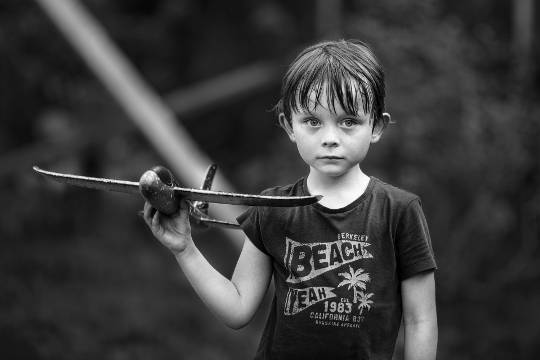 Today's Inspiration: December 15, 2022 a child holding a balsa wood airplane