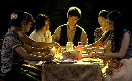 Today's Inspiration: December 22, 2022 a group of people sitting around a table sharing a meal