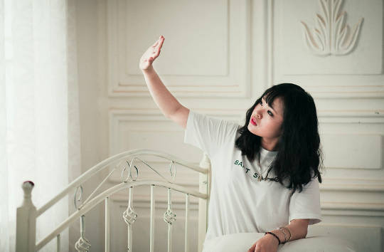 Prevention: The Ultimate Tool for Your Health young woman sitting on her bed