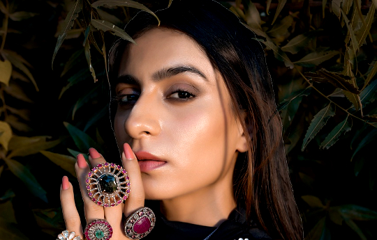 Working with Crystals and Gems by Wearing Gemstones with Intention a woman wearing multiple gemstone rings on her fingers