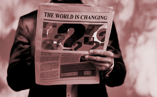 Reinventing Ourselves through the Power of Change a man reading a newspaper with the headline "The World is Changing"
