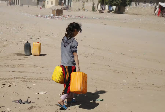 Yemeni girl holds water jerrycans after filling them from a donated tank amid a water shortage Yemeni girl holds water jerrycans after filling them from a donated tank amid a water shortage
