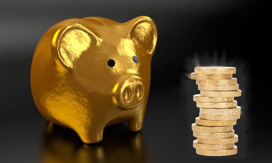 Tuning in to a Daily Practice of Gratitude: The Gratitude Bank a gold piggy bank with a stack of golden coins