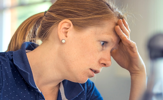 Five Pitfalls of Being Stuck in Your Helper Pattern tired-looking woman with her hand on her forehead