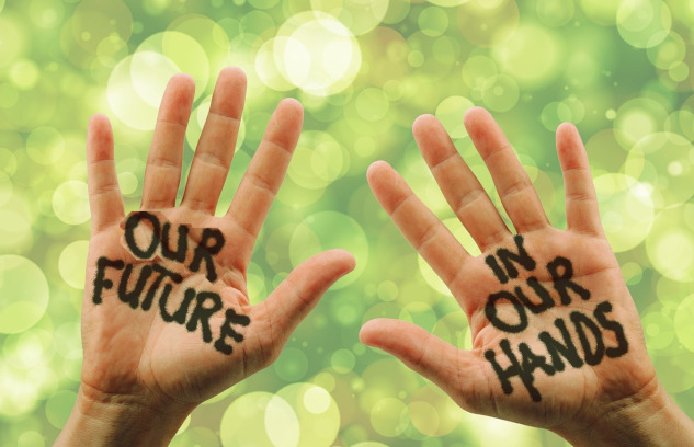 Taking Personal Responsibility: The Pros and Cons photo of two open hands with the words painted on them: Our Future in Our Hands