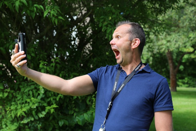 Is Power a Drug, or a Means to Happiness? a man shouting into his cell phone which he is holding a arm's length