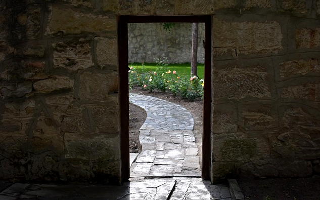 Life After Death? Exploring the Medium Path an door opening onto a pastoral scene