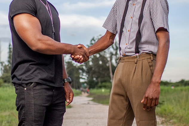 In Today's Divided World, Learn How to Disagree Better two men from different backgrounds shaking hands