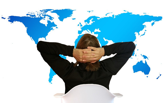 Balancing Life’s Demands: There’s Only So Much We Can Do a person sitting looking on at the laid-out map of all the countries on planet earth