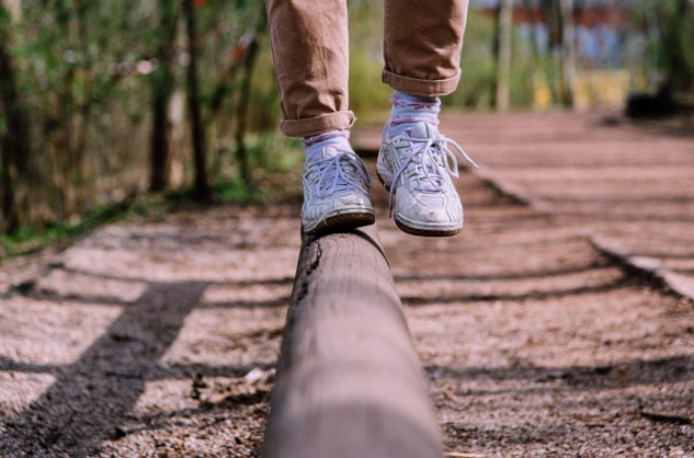 Techniques to Maintain Life Perspective and Find Balance showing the feet and legs of someone balancing on one foot