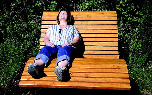 Embrace Each Day: How to Start Fresh and Let Go a woman relaxing on a bench with the sun shining on her