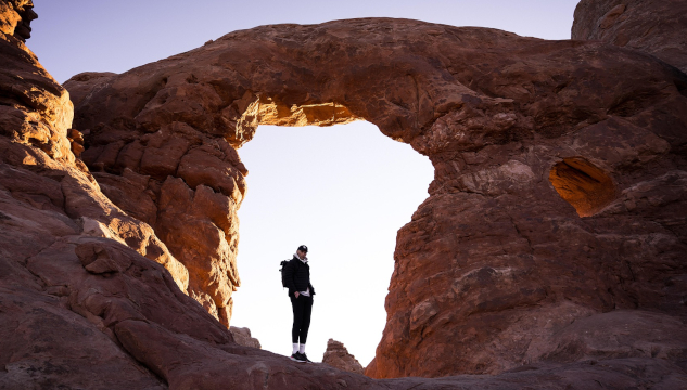 Embracing the Journey to Your Higher Power A man standing in a the bright space of an arch amidst rock. Image by Eric Barrett from Pixabay.